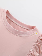 Pink cotton baby dress with ruffle sleeves and floral applique detail.