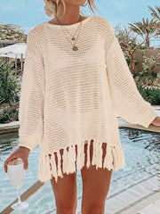 Cream open-knit acrylic beach cover-up with fringe hem and long sleeves.