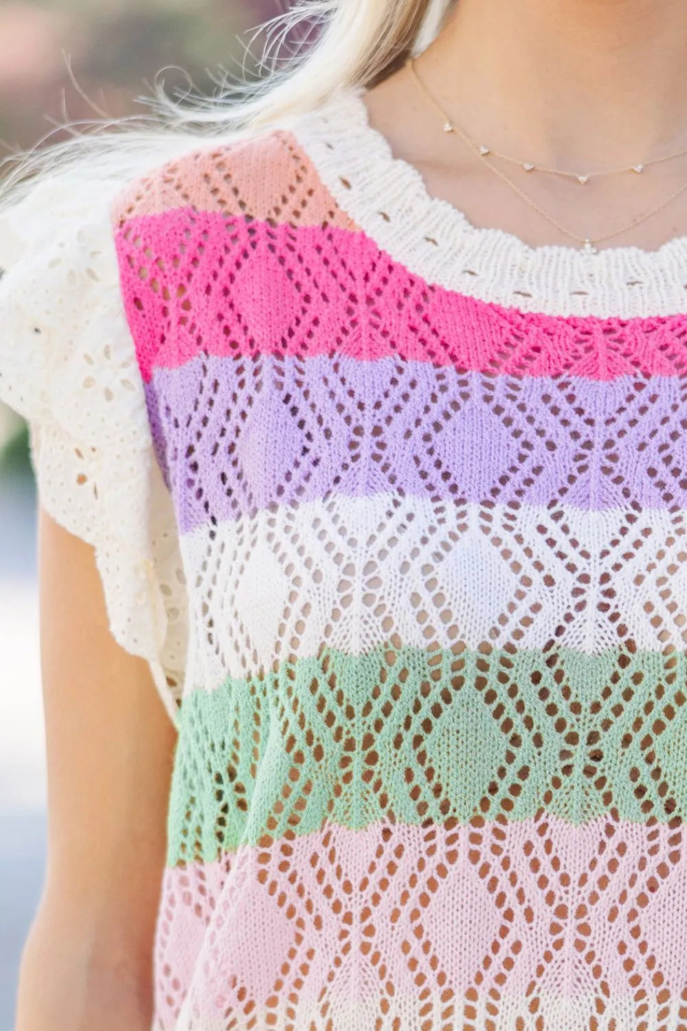 Rainbow crochet blouse with flutter sleeves and diamond pattern in stripe colors.