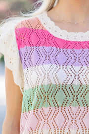 Rainbow crochet blouse with flutter sleeves and diamond pattern in stripe colors.