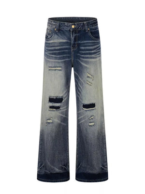 Men's distressed blue wide-leg bootcut jeans with ripped details