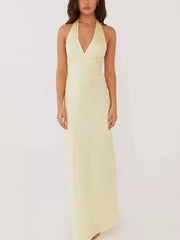 Pastel yellow cotton backless halter neck maxi dress with deep V-neck.