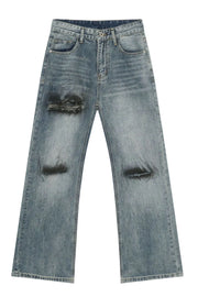 Distressed flare leg jeans in medium wash cotton denim with ripped details.