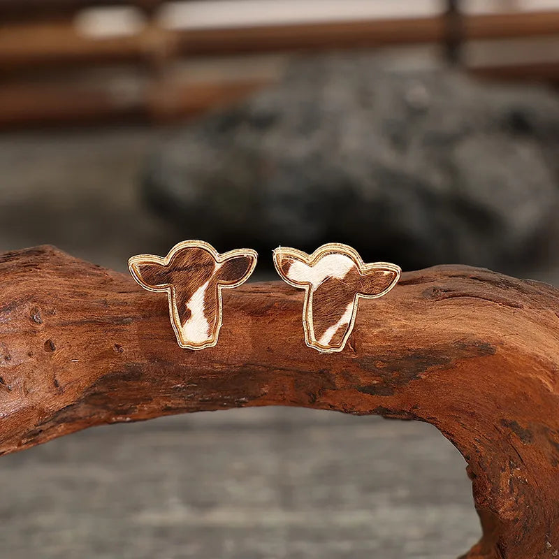 Cowhide silhouette stud earrings in copper with gold trim.