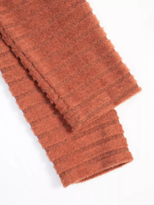 Ribbed knit A-line dress with long sleeves in rust, featuring horizontal textured stripes.