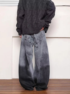 Men's washed wide leg jeans in grey with distressed details and a gradient dye effect.