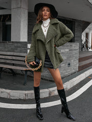 Green asymmetrical teddy moto jacket with a collared neckline and zip closure.