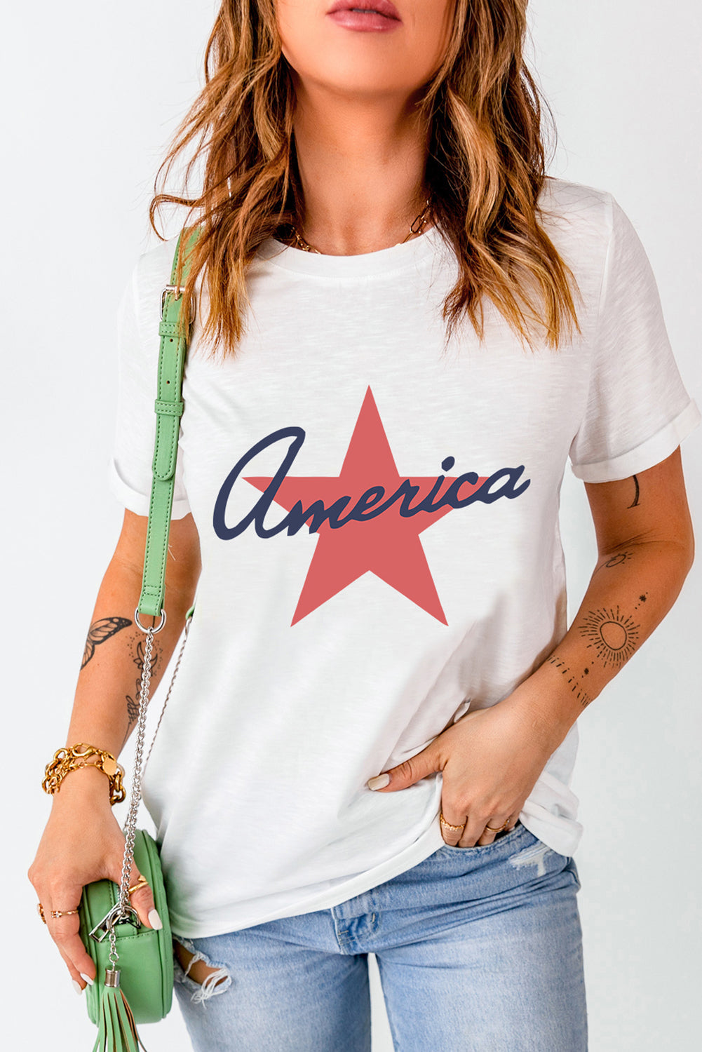 White t-shirt with red star and navy blue "America" graphic, casual crew neck tee.