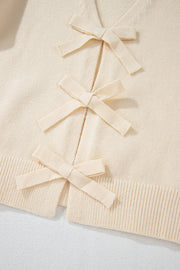 Ivory bouclé knit cardigan with tie-front bow details