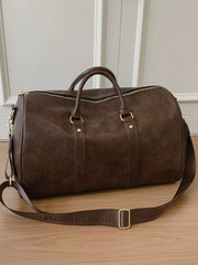 Brown pu leather travel bag with adjustable strap and gold hardware.