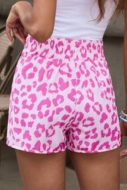 Pink leopard print shorts with elastic waistband and scalloped hem.