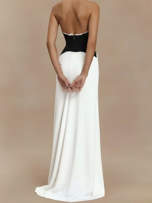 Black and white lace trim halter neck maxi dress with a flowing skirt.