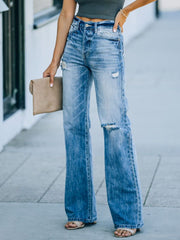Wide-leg distressed denim jeans in Dusty Blue with a high rise and ripped details.