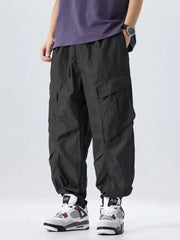 Black oversized cargo pants with adjustable drawstring waist and large side pockets.