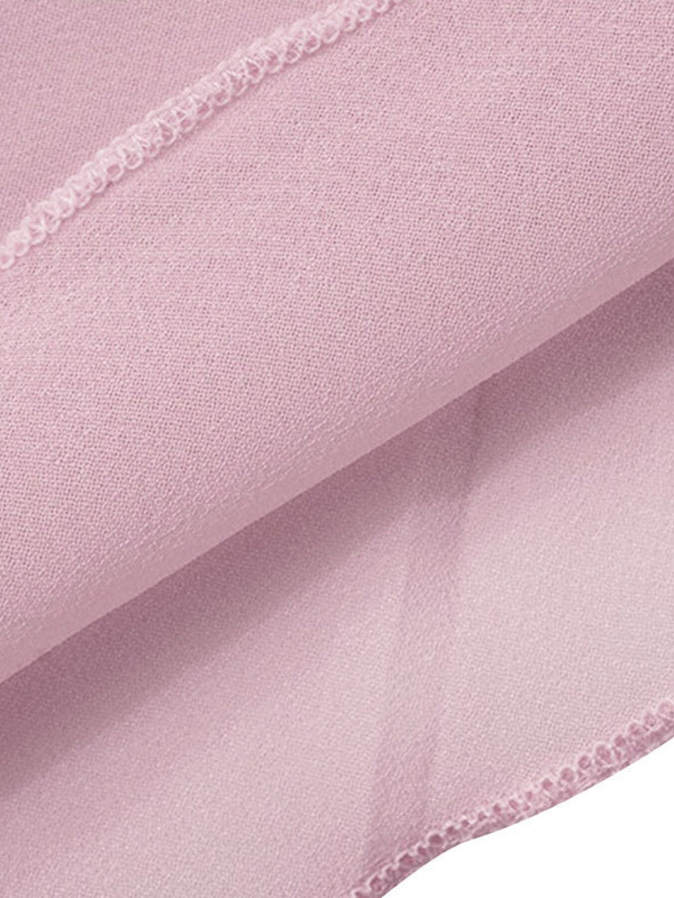 Backless sheer chiffon mini dress in pale pink with draped fabric detail.