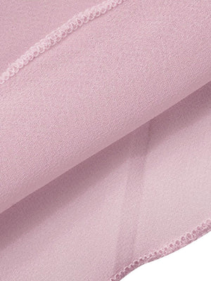 Backless sheer chiffon mini dress in pale pink with draped fabric detail.