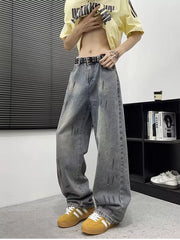 Men's wide-leg denim jeans in blue with distressed details and paint splatters.