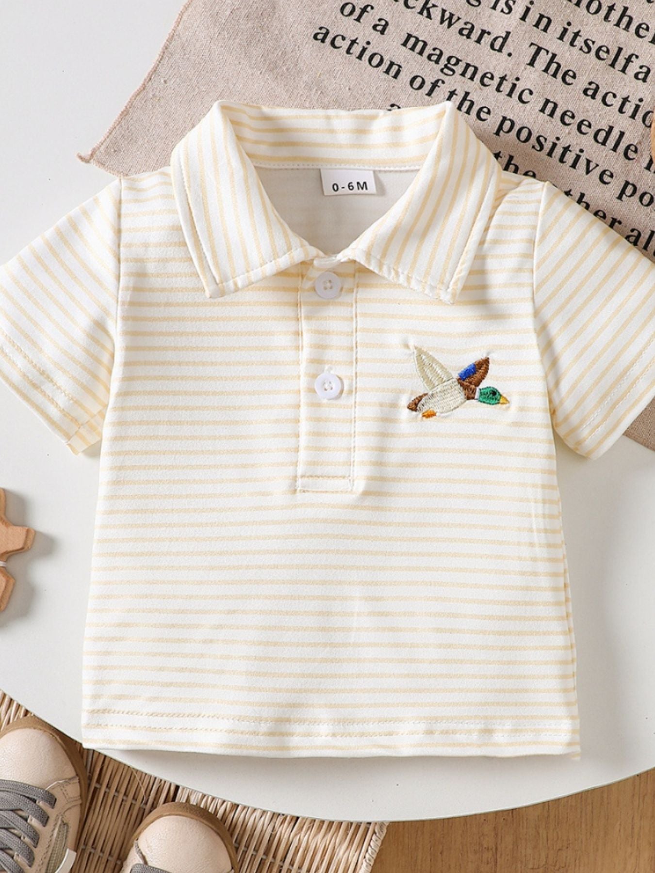 Light Yellow striped cotton polo shirt for baby with embroidered duck detail.