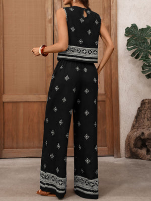 Black sleeveless geometric print crop top and wide-leg pants set with embroidered details.