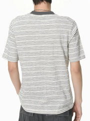 Essential striped crew neck t-shirt in white with black stripes, made of comfortable cotton.