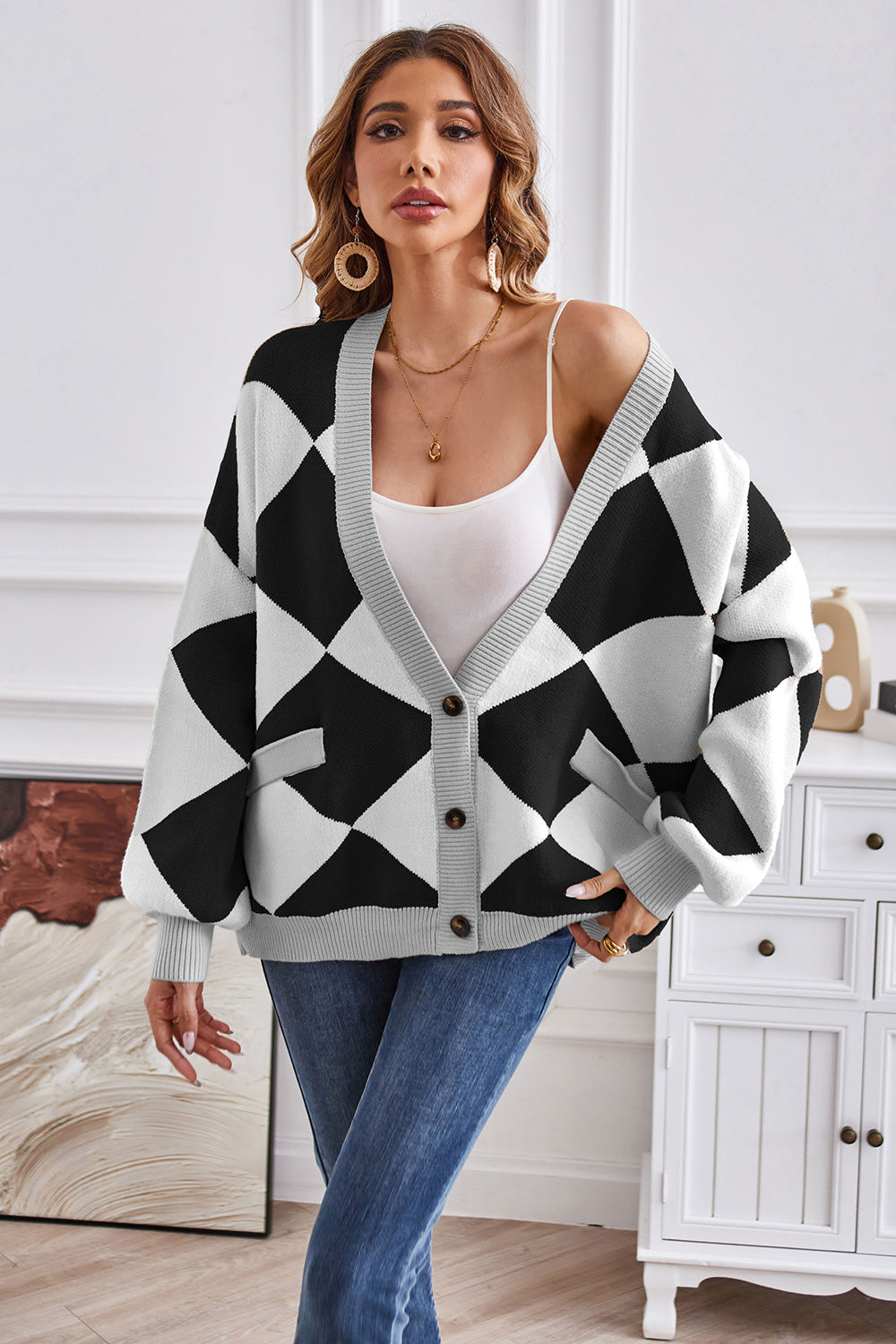 Diamond knit balloon sleeve cardigan in black and white with gray trim and pockets.