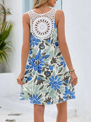 Botanical print mini dress with white crochet detail on back, blue-green flower pattern.