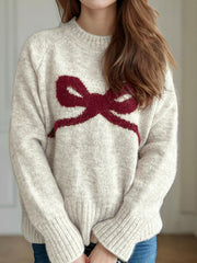 Beige knit sweater with crimson bow intarsia, crew neck, long sleeves, ribbed cuffs and hem.