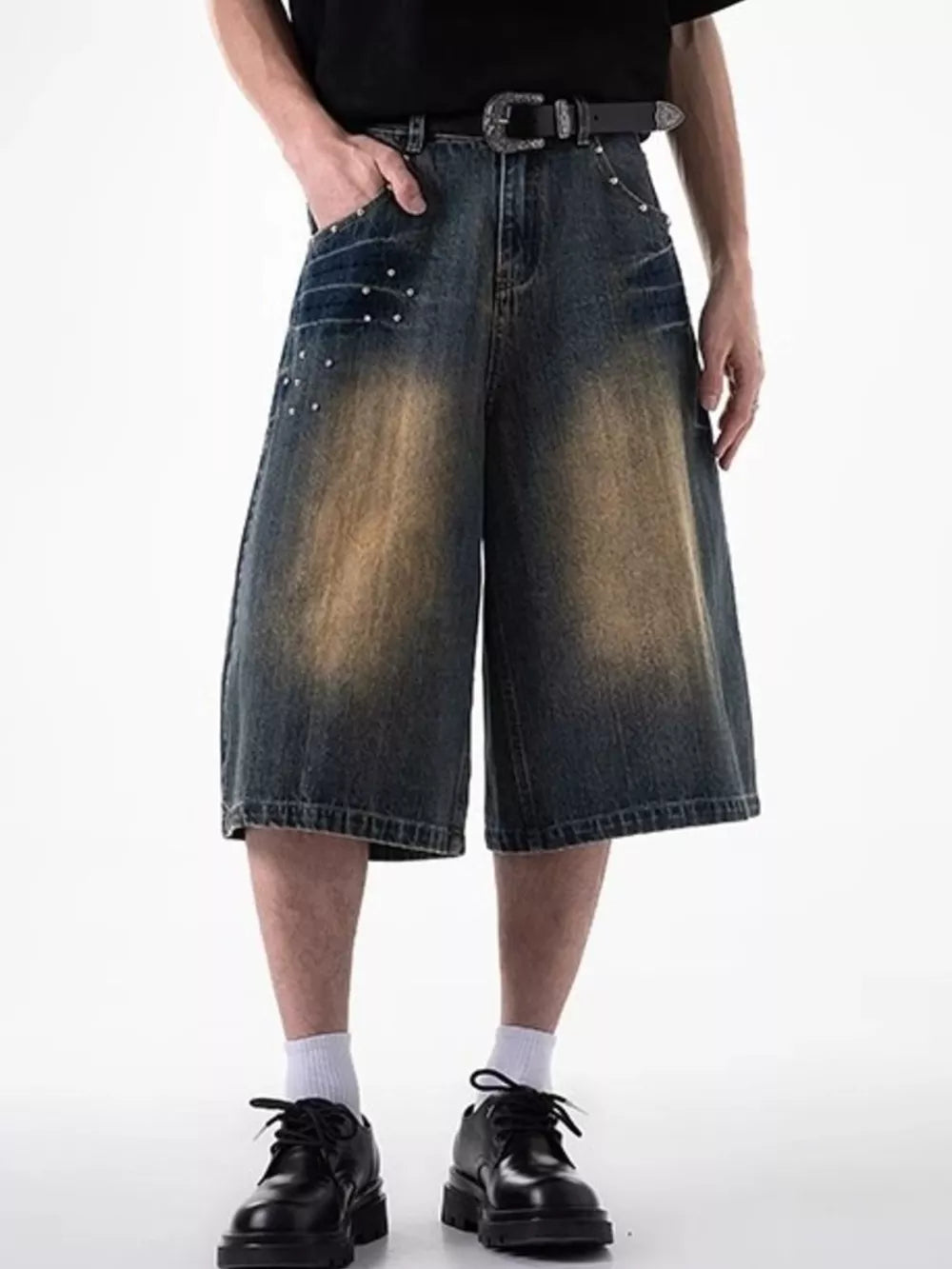 Relaxed fit denim shorts in dark blue with distressed details and coin pocket.