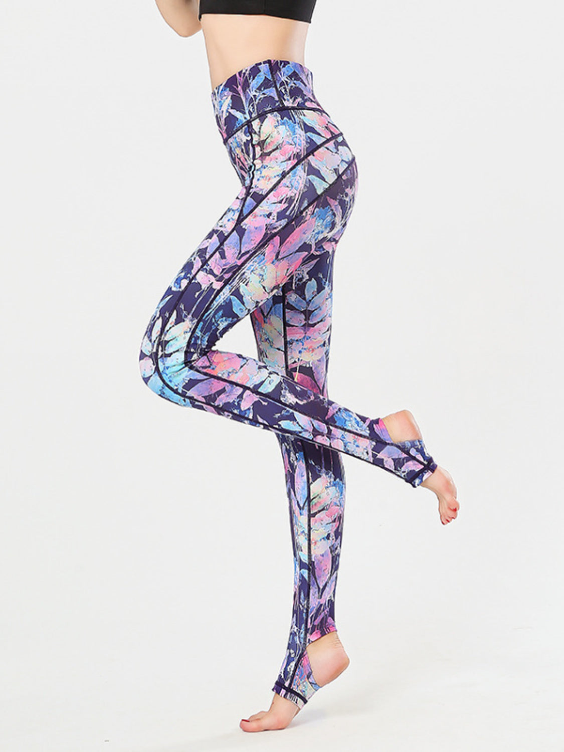 Prism Palm stirrup leggings in a colorful leaf print with black contrast stitching.