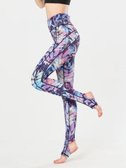 Prism Palm stirrup leggings in a colorful leaf print with black contrast stitching.