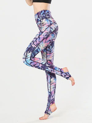 Prism Palm stirrup leggings in a colorful leaf print with black contrast stitching.