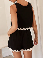 Black linen tank and shorts set with scalloped trim and a relaxed fit.