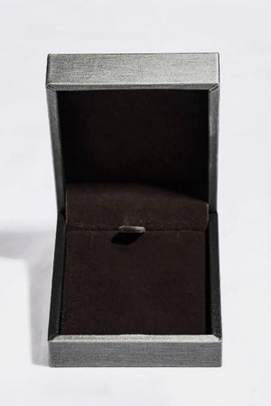 Open jewelry box with dark green velvet lining and silver textured exterior.