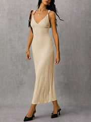 Ivory ribbed midi dress with crisscross straps and a V-neck.