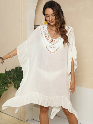Ivory crochet yoke ruffle hem cover-up with V-neck and flutter sleeves.