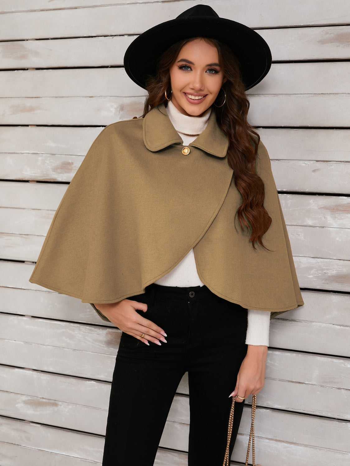 Camel asymmetric button-front cape jacket with a collared neckline and single gold button detail.