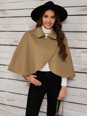 Camel asymmetric button-front cape jacket with a collared neckline and single gold button detail.