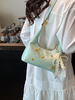 Light green mini hobo bag with gold accents and pearl charm.