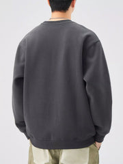 Men's oversized dark gray graphic sweatshirt with crew neck and ribbed cuffs and hem.