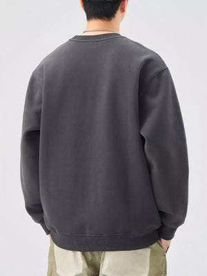 Men's oversized dark gray graphic sweatshirt with crew neck and ribbed cuffs and hem.