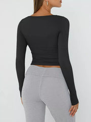 Black long sleeve cropped t-shirt with ruching detail at the waist