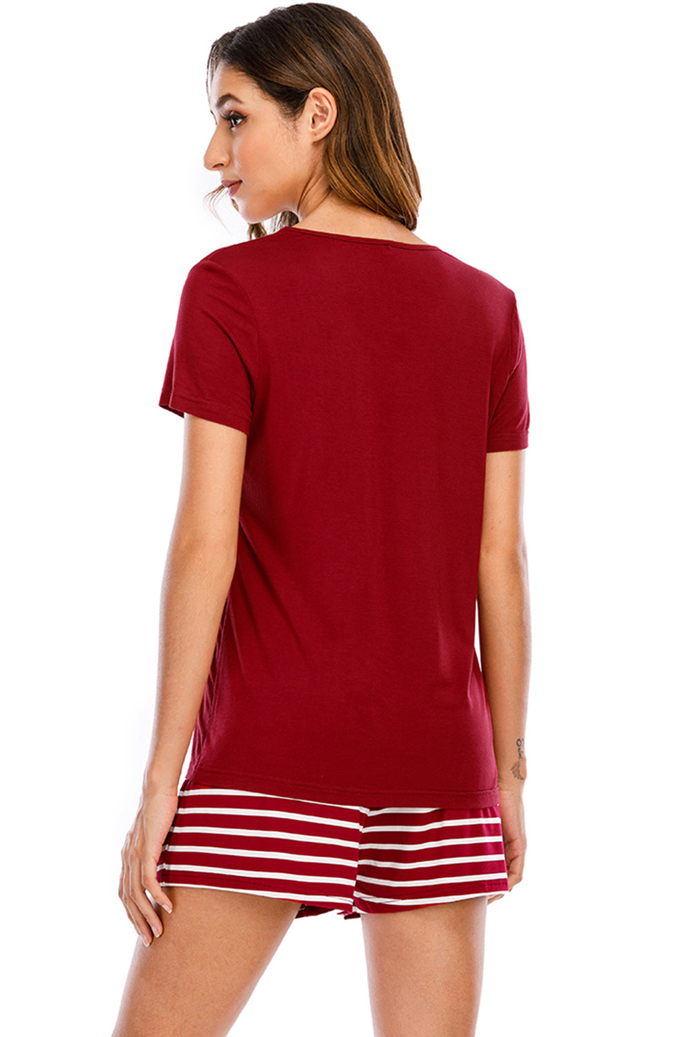Scarlet graphic tee with white striped shorts.