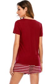 Scarlet graphic tee with white striped shorts.