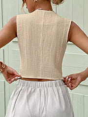 Apricot textured cotton cropped vest with button detail.