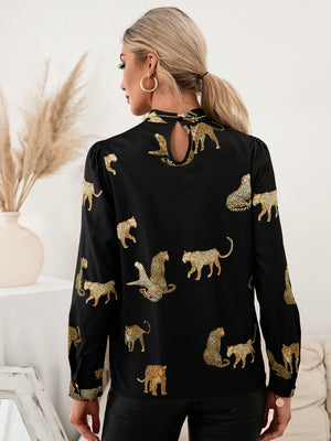 Black leopard print blouse with keyhole neck and puff sleeves.