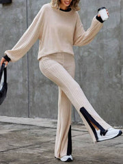 Tan ribbed knit lounge set with slit hem pants and crewneck sweater.