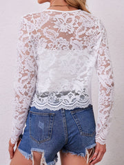 White lace bolero jacket with long sleeves and scalloped hem, worn over a camisole.