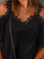 Black cold-shoulder flutter top with lace trim neckline and sleeves.