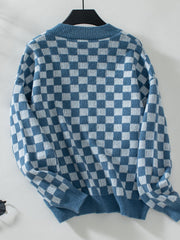 Checkerboard knit pullover sweater in dusty blue and white with a crew neck.