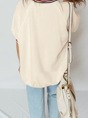 Beige cotton tunic top with striped neckline and raw hem detail.